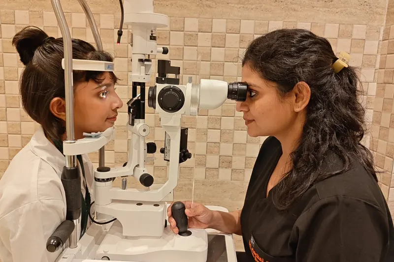 Dr. Anchal Gupta examining a young girl at the slit lamp