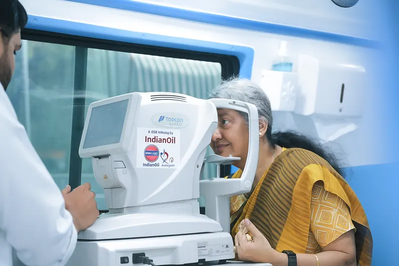 A patient having her eyes tested on a Topcon auto-refractor inside the Nayan Hans mobile eye-care van