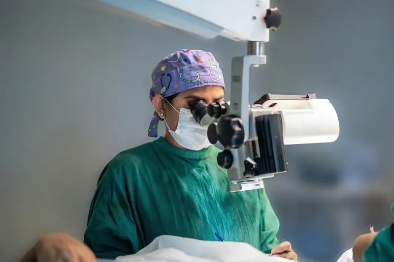 Dr. Anchal Gupta performing cataract surgery at the operating microscope